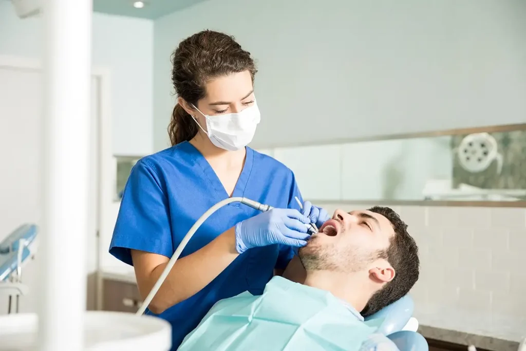 Dental hygienist cleaning a patient's teeth