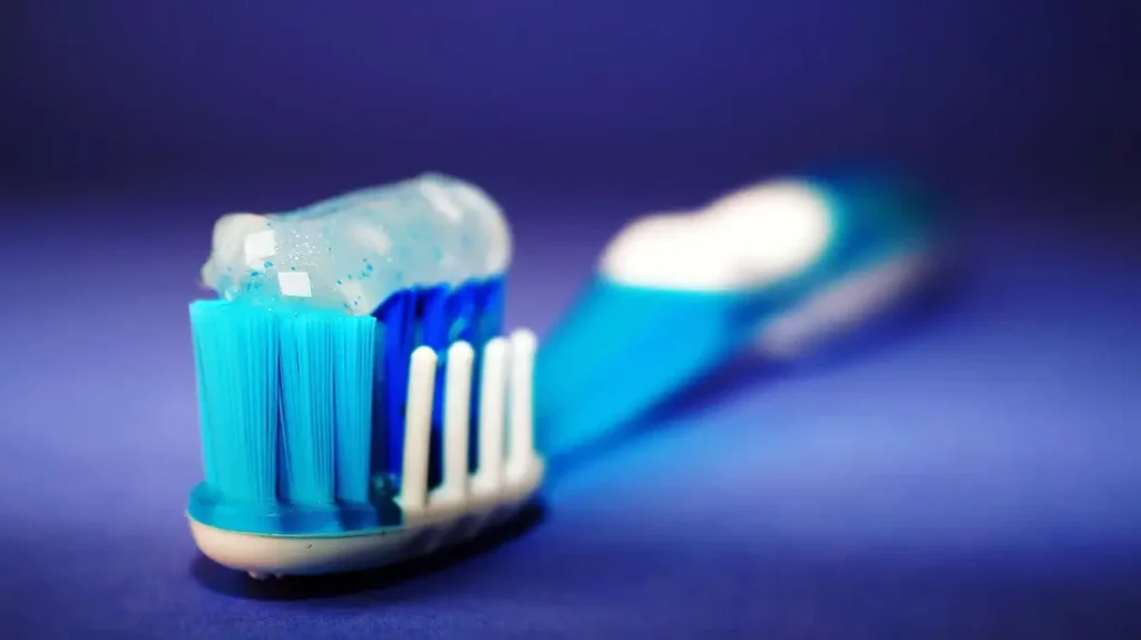 Blue toothbrush with toothpaste.