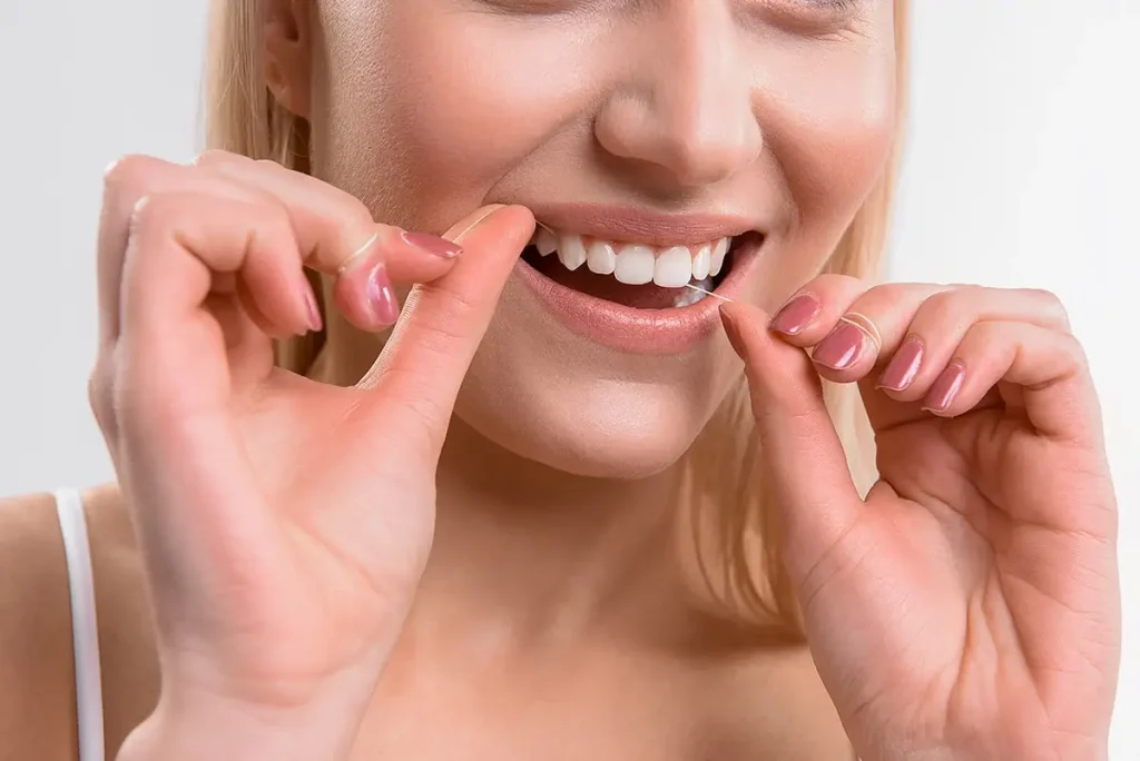 Woman flossing white teeth