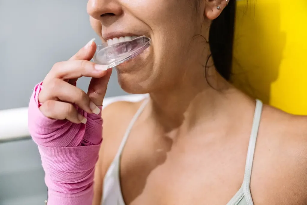 Person putting in sports mouth guard.