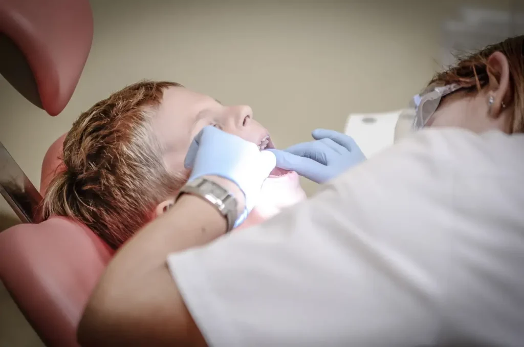 Dentist examining young patient.